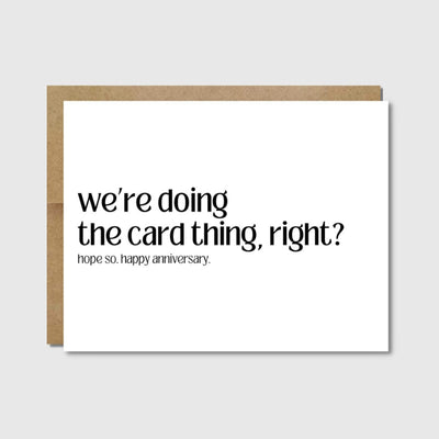 The Raisin Spirits Funny Anniversary Card | Were Doing The Card Thing Right? features bold black text on a white A2 heavy card stock and comes with a kraft envelope, shown against a light gray background.