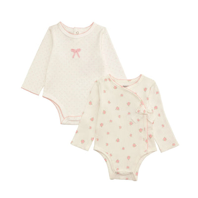 The Mud Pie Floral & Bow Crawlers set includes two soft cotton interlock baby bodysuits: one with pink polka dots and an embroidered bow, another off-white with a pink floral print and kimono-style side-tie bow.