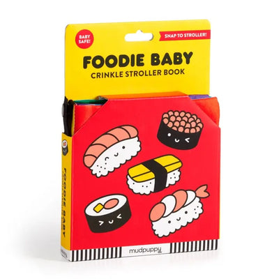 The Chronicle Books Foodie Baby Crinkle Fabric Stroller Book features cute sushi illustrations in red packaging. Labeled “Baby Safe!” and “Snap to Stroller!,” it’s a perfect early learning toy for little ones.