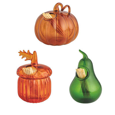 Mud Pie Gather Toothpick Caddy Sets include three glass holders—a pumpkin, acorn, and green pear—each filled with wooden toothpicks. The pumpkin and acorn are orange, while the pear is green.
