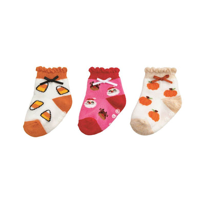 Mud Pie Girl My First Holiday Sock Set includes three pairs of baby cotton socks with autumn designs: candy corn with grosgrain bows, pink owls and acorns with white bows, and orange pumpkins with beige bows—all featuring scallop edges.