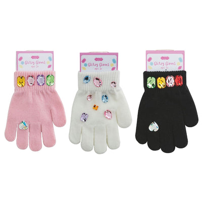 Three pairs of Mud Pie Glitzy Gloves—pink, white, and black sweater knit—each with colorful rhinestones. The packaging features pastel polka dots for added charm.