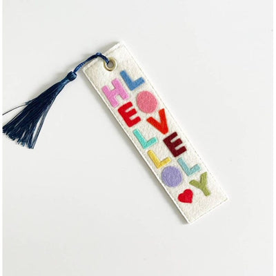 The Milo & Mollie Hello Lovely Felt Bookmark features white wool felt, colorful handmade felt HELLO LOVELY letters, a small red heart, and a navy blue tassel—an ideal gift for book lovers.