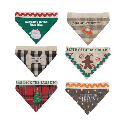 Mud Pie’s Reversible Holiday Pet Bandanas include six cotton bandanas with festive designs like Santa, pie, and a gingerbread man. Each features a handy hook and loop closure, all set against a white background.