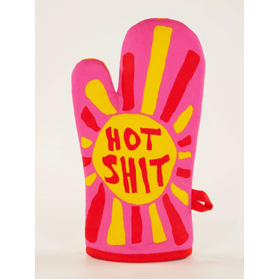 The Blue Q Hot Shit Oven Mitt features bold pink with yellow and red rays, proudly displaying HOT SHIT—ideal for anyone who loves spicy food or wants to add personality to their kitchen.