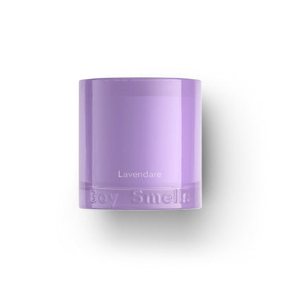 The Lavendare Essentials Candle by Boy Smells is housed in a lavender glass jar with “Lavendare” printed in white and “Boy Smells” embossed on the bottom, offering a calming fragrance. The photo shows it on a plain white background with a soft shadow.