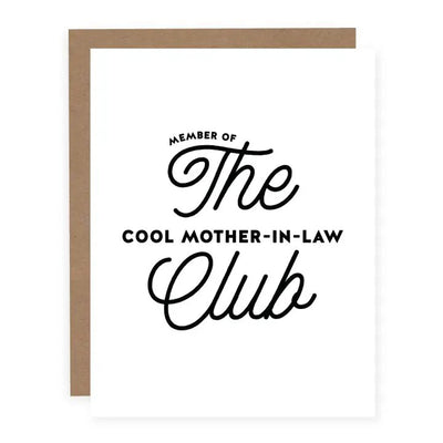 The Cool Mother-in-Law Club Card by pretty by her features a brown paper backing and matte cardstock. The front displays Member of The Cool Mother-in-Law Club in black, stylized fonts on a white background. This A2 folded card is blank inside for your personal message.