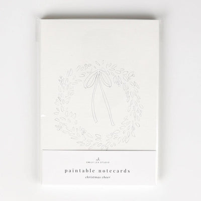 The Emily Lex Studio Christmas Cheer Paintable Notecard features a simple outlined wreath and bow design, packaged in plastic—ideal for DIY or watercolor Christmas cards.