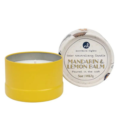 Yellow candle in a tin with a white label on a white background