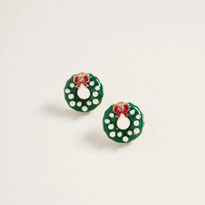 Golden Stella's Enamel Christmas Wreath Earrings feature green wreaths with pearl ornaments and red bows, crafted from zinc. Measuring 0.5 inch across, these festive studs are displayed on a plain white background.