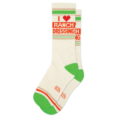 The I Heart Ranch Dressing Gym Crew Socks by Gumball Poodle are unisex white cotton socks with green heels and toes, orange and green stripes, and “I ♥ Ranch Dressing” at the top—ideal for any ranch fan seeking fun footwear.