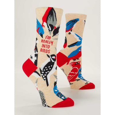 Blue Qs Really Into Birds Womens Crew Socks feature vibrant bird illustrations, beige fabric, and red accents. One sock displays IM REALLY INTO BIRDS—a perfect novelty gift for bird lovers.