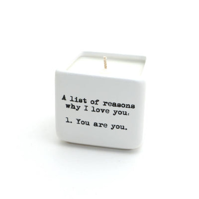 The Lenny Mud Reasons I Love You Hand Poured 8 oz. Soy Candle features a white ceramic pot with black text listing reasons for love. This unscented soy wax candle is unlit and displayed centered on a white background.