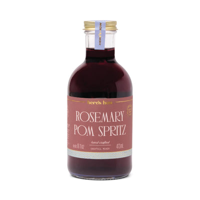 Bottle of Rosemary Pom Spritz cocktail mixer with a gold cap on a white background