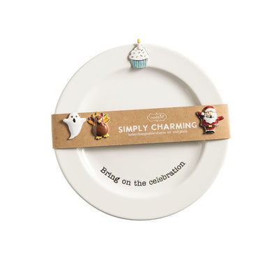The Mud Pie Simply Charming Holiday Plate Set features a beaded ceramic plate with festive designs—a ghost, turkey, cupcake, and Santa—plus an interchangeable magnet and a brown SIMPLY CHARMING interchangeable charm set and plate band.