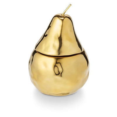 The Spiced Pear Holiday Fruit Candle by Illume Candles features a shiny gold, pear-shaped container with a removable lid and short stem, filled with plant-based wax, set against a plain white background.