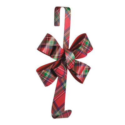 The Mud Pie Tartan Bow Wreath Hanger features a large red, green, and white plaid bow, a hook for your wreath at the bottom, and a curved top for hanging on your door.