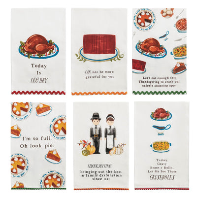 Mud Pie’s Thanksgiving Trim Towels set includes six cotton hand towels with festive illustrations and humorous sayings, featuring turkeys, pie, casseroles, pilgrims, and plates—each finished with a mini pom hem.