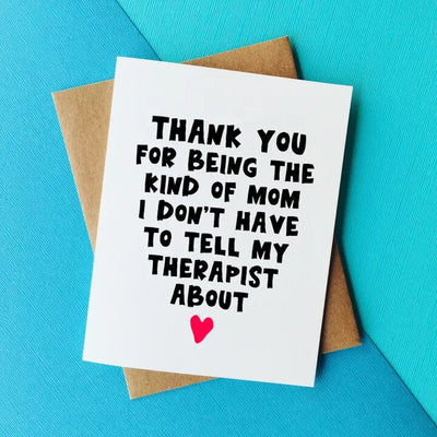 The Top Hat and Monocle Therapist Mothers Day Greeting Card features a humorous message, Thank you for being the kind of mom I don’t have to tell my therapist about, on a blue background with a red heart. It is crafted on high-quality card stock and includes a brown envelope, leaving the inside blank for your personal note.