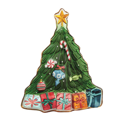 The Mud Pie Christmas Tree Glass Platter features a hand-painted tree with green icing, a yellow star, ornaments, a candy cane, and five colorful presents on a white background.