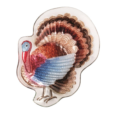 The Mud Pie Turkey Platter is a decorative fused glass serving dish shaped like a turkey and hand-painted with detailed brown, red, blue, and cream feathers.