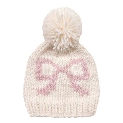 Knitted hat with a pom-pom on a white background