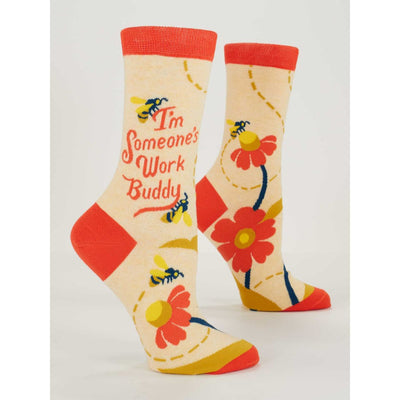 Blue Q Work Buddy Women’s Crew Socks in size 5-10 feature cream color with red toes, heels, and cuffs, bees, red and yellow flowers, and “I’m Someone’s Work Buddy” in red cursive. Made from soft combed cotton for all-day comfort.