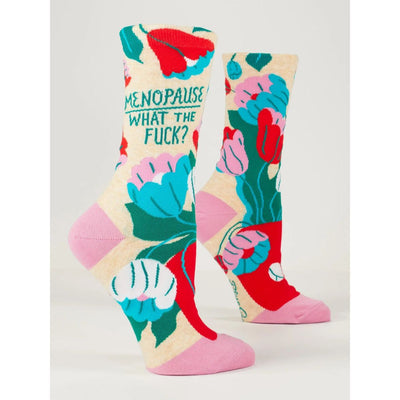 Blue Q Menopause Womens Crew Socks feature a vibrant floral design with the phrase Menopause: What the fuck? on the side. Made from soft combed cotton in pink, red, blue, white, and green for comfort and striking style.