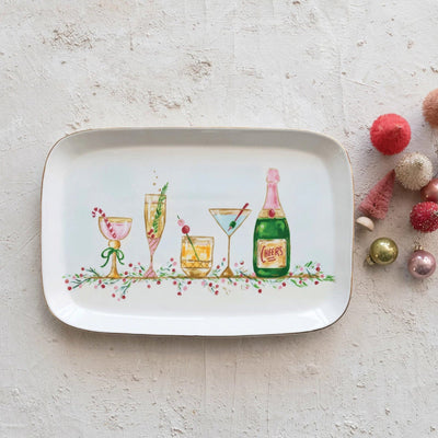 The Creative Co-op Holiday Cocktails Stoneware Platter features lively illustrations of champagne, cocktails, and a "Cheers" bottle with festive holiday decorations on a textured white background. UNAVAILABLE FOR SHIPPING.