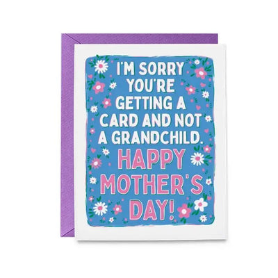 The No Grandchildren Mothers Day Greeting Card by Hello Harlot has a blue floral design and a matching purple envelope. It features the message: Im sorry youre getting a card and not a grandchild. Happy Mothers Day! in white and pink text, with a blank interior for your note.