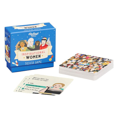 A blue box labeled “Inspirational Women Trivia Game” by Chronicle Books sits beside illustrated cards of diverse women and trivia cards from this empowering quiz featuring notable female trailblazers.